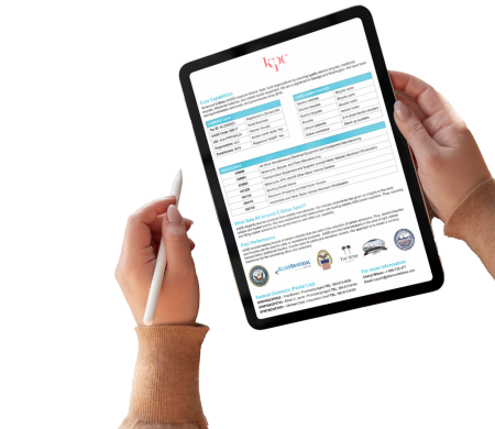 A person holds a tablet displaying a document from "kpc" with a stylus in their right hand. The document includes tables and multiple sections, while badges and logos are visible at the bottom.